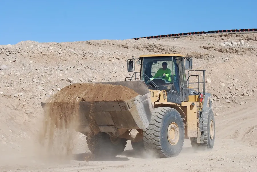 caterpillar wheel loader filling aggregate stockpile at sourced quarry outside las vegas