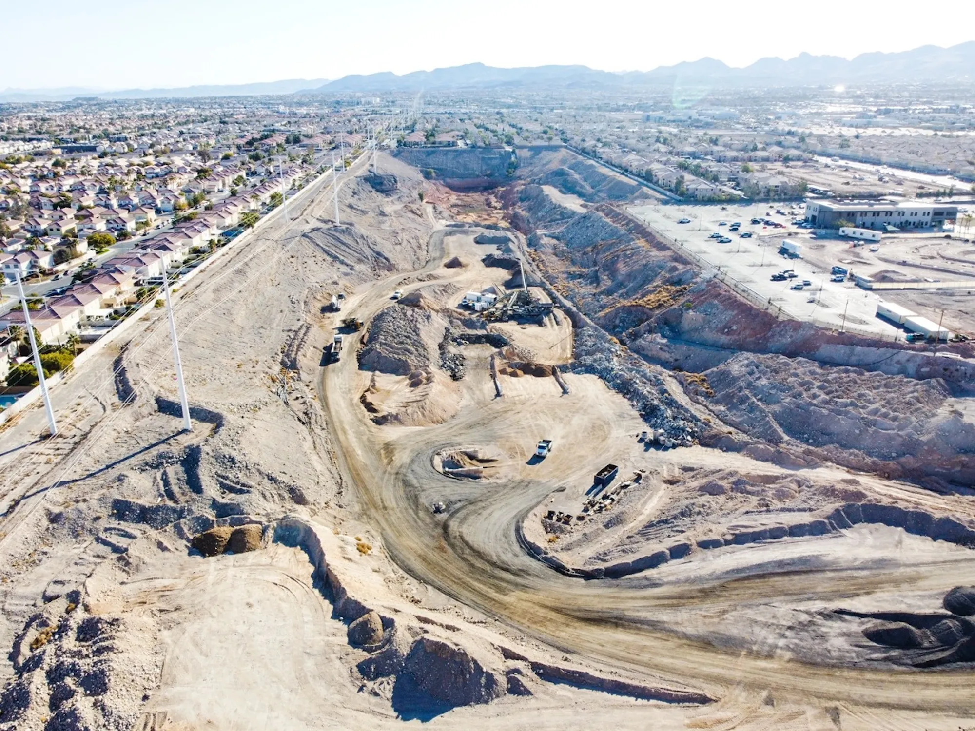 aerial view of impact sand and gravel quarry operations outside las vegas with wheel loaders and haul trucks