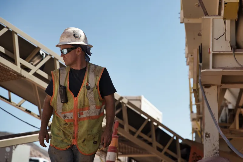 impact sand and gravel worker under the conveyor and crusher at the las vegas quarry