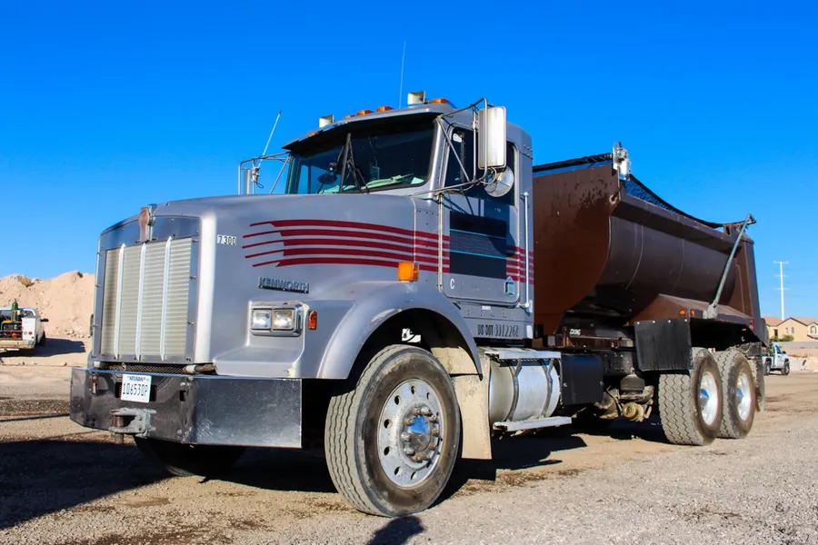 impact sand and gravel dump truck delivering bulk material in las vegas