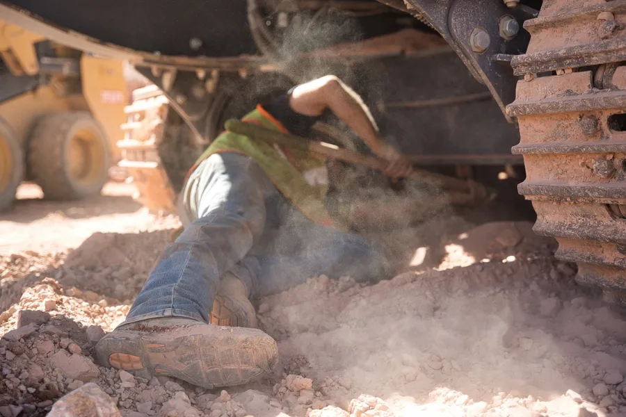 impact sand and gravel workers performing maintenance on quarry equipment together in las vegas