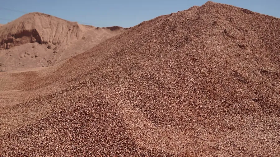 red rock stockpile at impact sand and gravel quarry