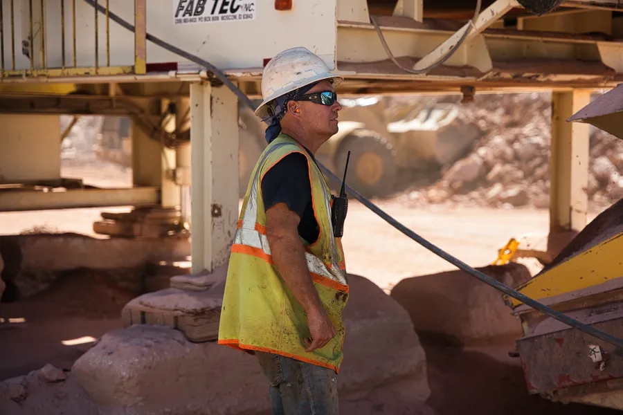quarry supervisor monitoring aggregate crusher at impact sand and gravel operation